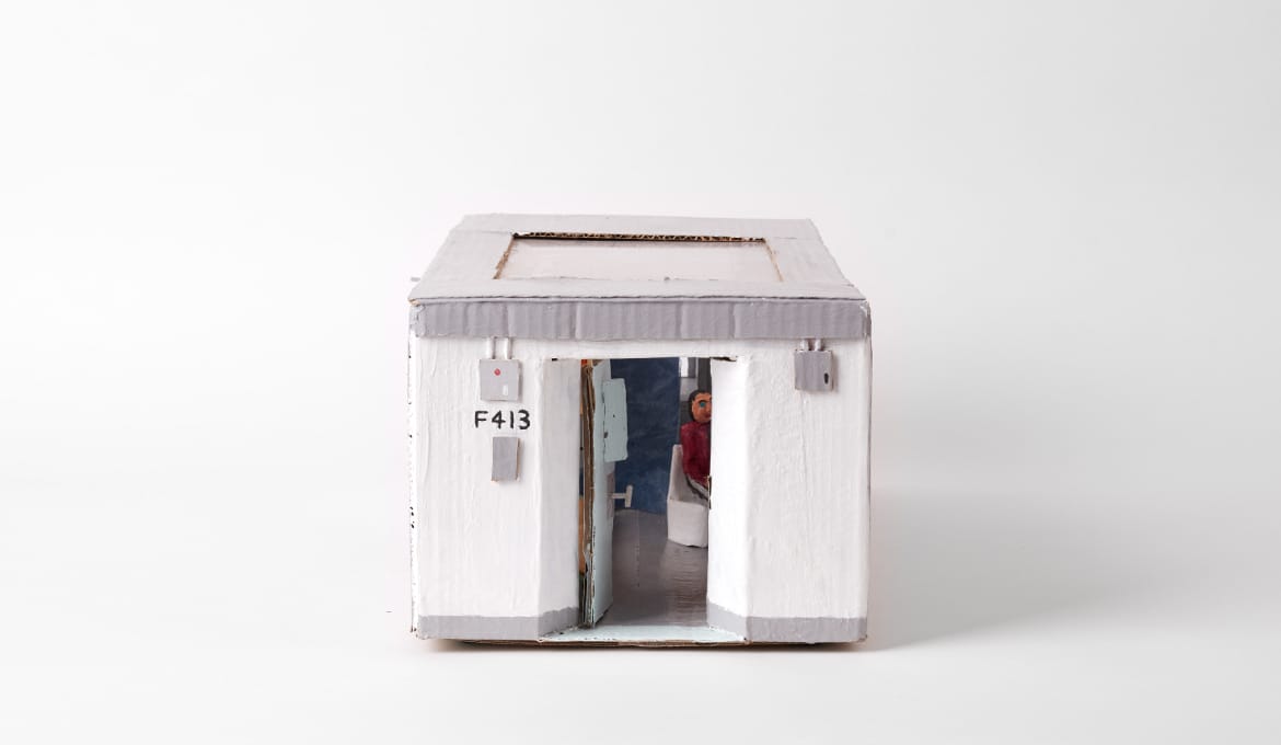A photo of a mini jail cell reconstructed from cardboard.