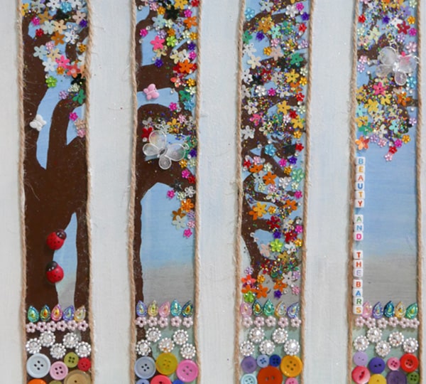 A multimedia art piece embellished with buttons creating the leaves for a tree.