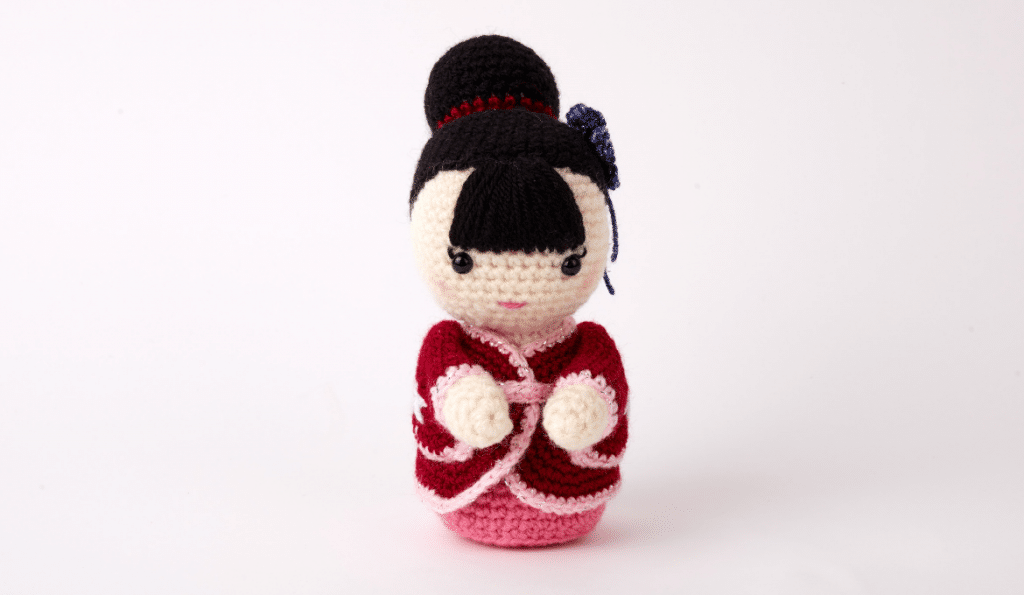 A photo of a crochet plushie doll.