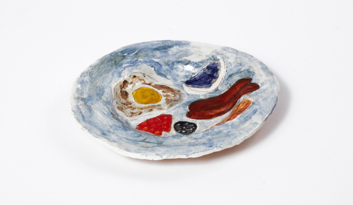 A sculpture of a plate with eggs, bacon and baked beans on.