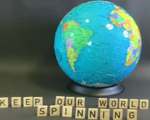 A photo of a globe with scrabble letters in front of it spelling 'Keep our world spinning'.
