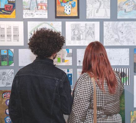 Two people looking at art at an exhibition