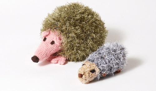 A photo of two crocheted hedgehogs.