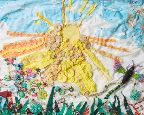 A mixed media piece of artwork featuring the sun and flowers made out of various textures.