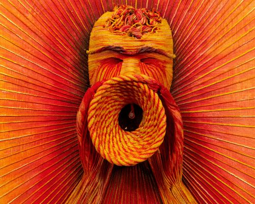 A woven 3D orange art piece of a head with his hands around his mouth with his mouth wide open.