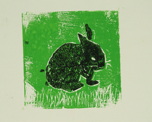 A graphic design of a black rabbit on a green background.