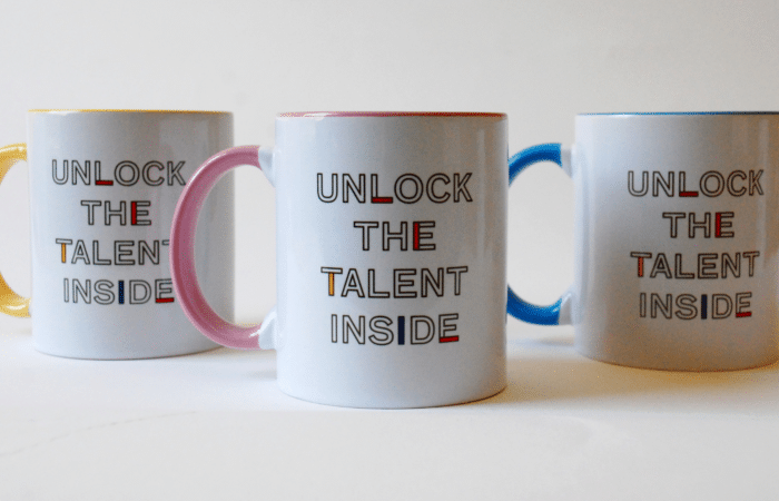 A photo of three mugs from Koestler Arts merchandise range.