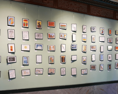 A photo of a wall filled with art at a Koestler Arts exhibition.