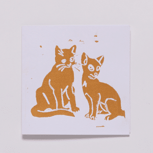 Greetings card with white background and print of two cats in orange-gold paint.