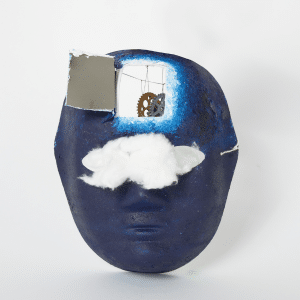 Mask of a face painted navy blue with cloud covering eyes and part of the forehead opened up, revealing a cog.