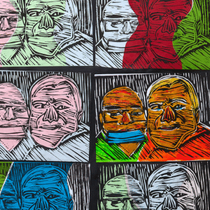 Repeated linoprint motif of father and son in different colours.
